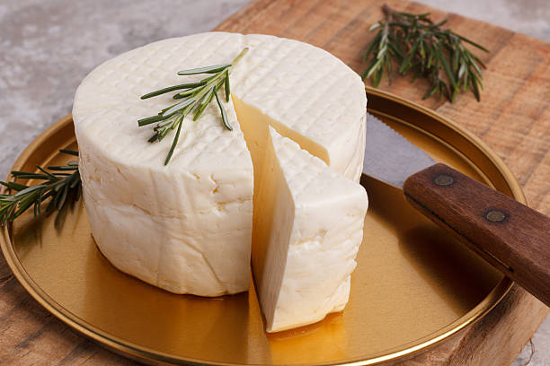 Wheel of brazilian traditional cheese Minas Wheel of brazilian traditional cheese Minas on wooden board. Selective focus white cheese stock pictures, royalty-free photos & images