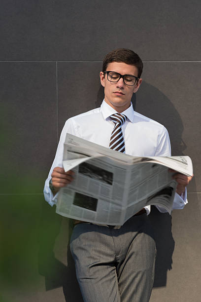 istock Businessman reading newspaper 585784148