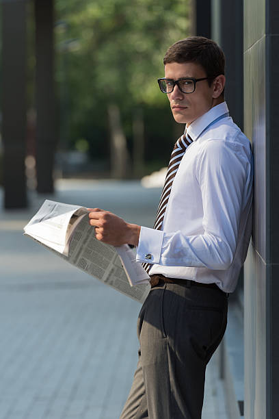 istock Businessman reading newspaper 585784412