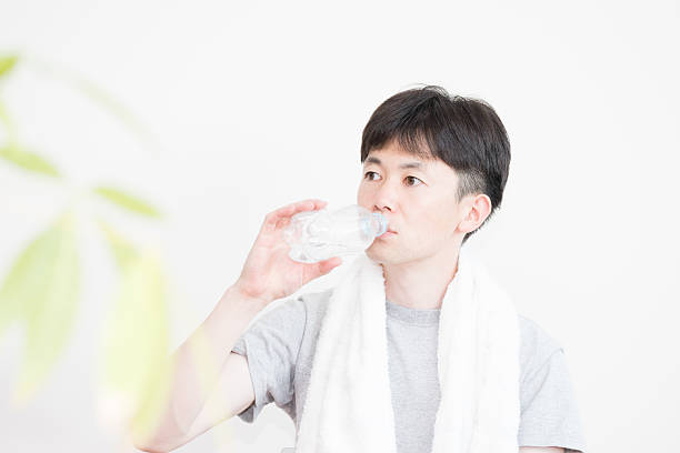istock Drink a sports drink man (training, diet, sweat, and health) 585789376