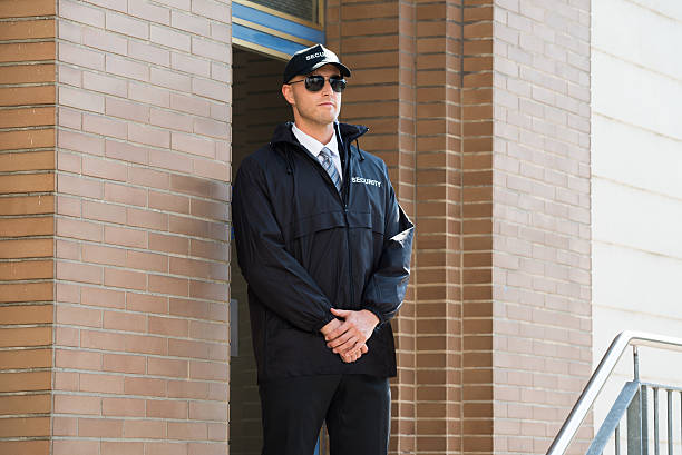 istock Male Security Guard Standing At The Entrance 585789454
