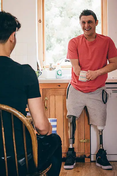 Photo of Amputee and his friend drinking tea