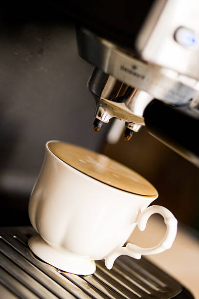 istock espresso machine making coffee and pouring in a white  cup 585791814