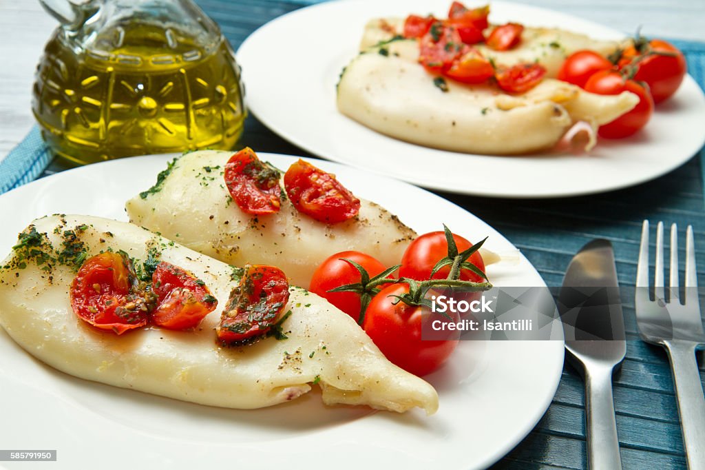 Baked squid Baked squid with fresh tomatoes and parsley Baked Stock Photo