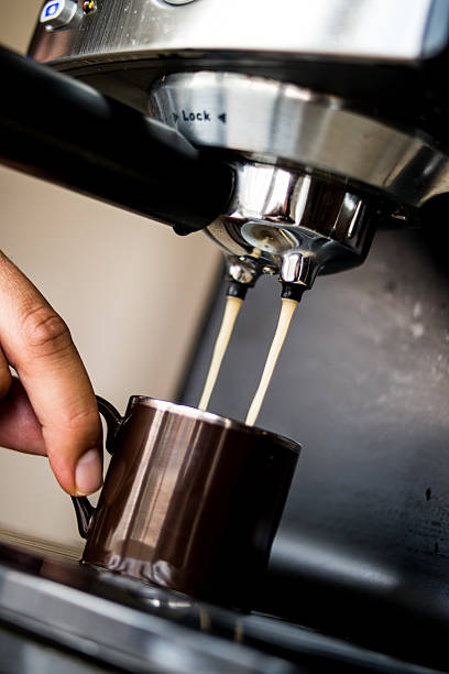 istock espresso machine making coffee and pouring in a brown  cup 585792710