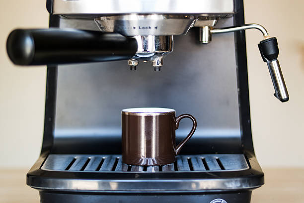 istock espresso machine making coffee and pouring in a brown  cup 585793956