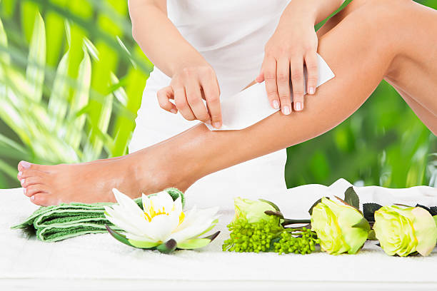 istock Beautician Waxing Woman's Leg In Spa 585794088