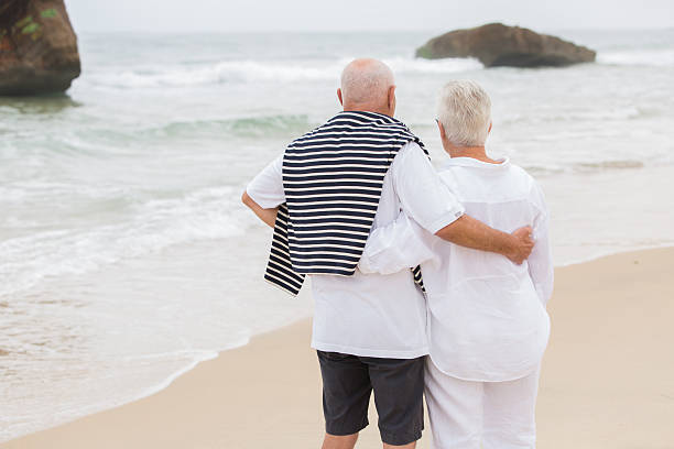 istock Senior Couple Enjoying Beach Holiday 585795586