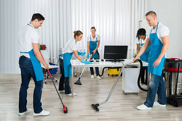 istock Group Of Janitors Cleaning The Office 585795608