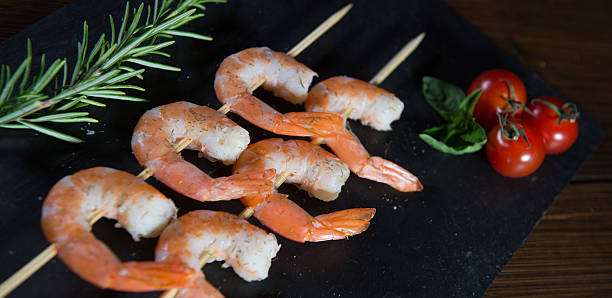 istock Prawn skewers with thyme and Tomatoes 585796188