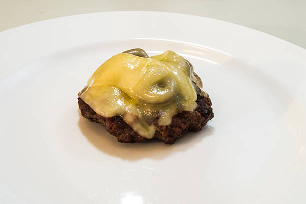 istock Close up mushrrom swiss burger on plate without a bun 585796324