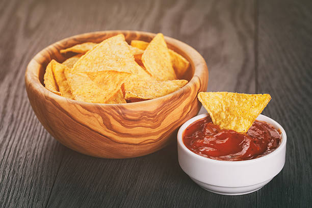 istock tortilla chips in olive wood bowl with tomato sauce 585797938