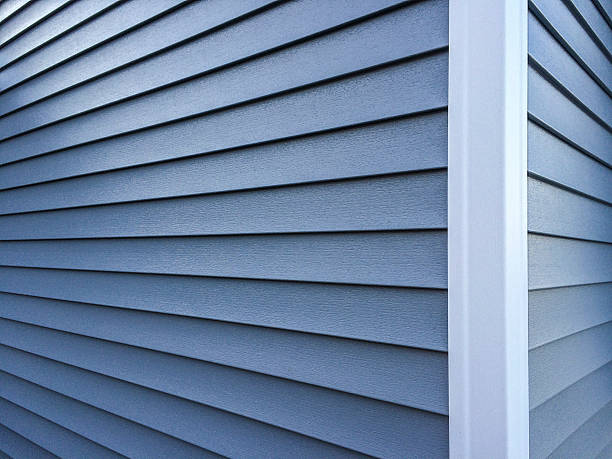 Blue Vinyl Siding Photography of new, blue vinyl siding on a home. vinyl siding stock pictures, royalty-free photos & images