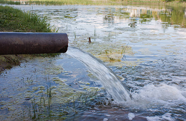 istock sewage from the sewer pollute a lake, river 585800364