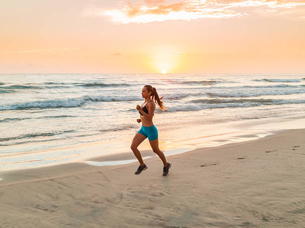 istock Hispanic Women Running At The Beach At Sunset 585802216