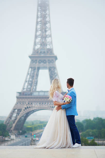 istock Just married couple near the Eiffel tower in Paris 585802628
