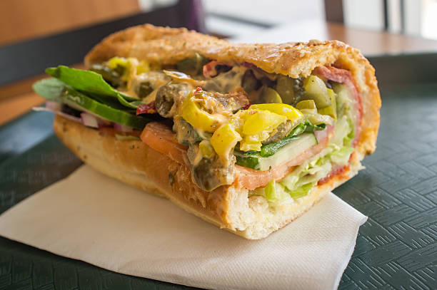 Everything Sub Sandwich Stuffed overflowing huge spicy sub sandwich with every topping torpedo sandwich stock pictures, royalty-free photos & images