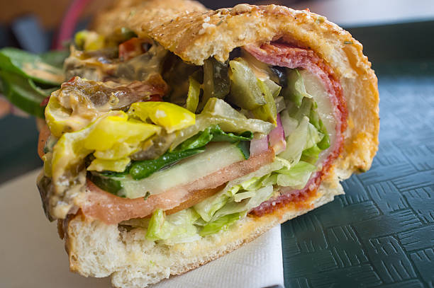 Everything Sub Sandwich Stuffed overflowing huge spicy sub sandwich with every topping torpedo sandwich stock pictures, royalty-free photos & images