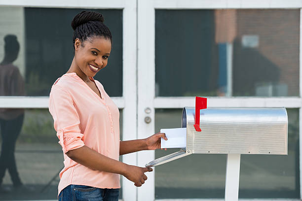 istock Woman Collecting Her Mail From Mailbox 585803230