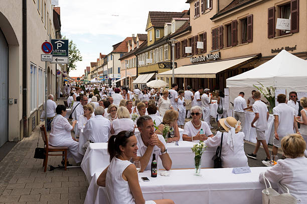 Le Diner En Blanc - the white dinner Ludwigsburg, Germany - July 30, 2016: People are enjoying le diner on blanc – the white dinner – where all guests are asked to dress in white, dining at white tables in Ludwigsburg near Stuttgart, Germany. ludwigsburg photos stock pictures, royalty-free photos & images