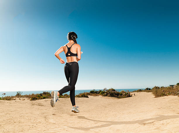 istock Hispanic Women Running At The Beach At Sunset 585803858