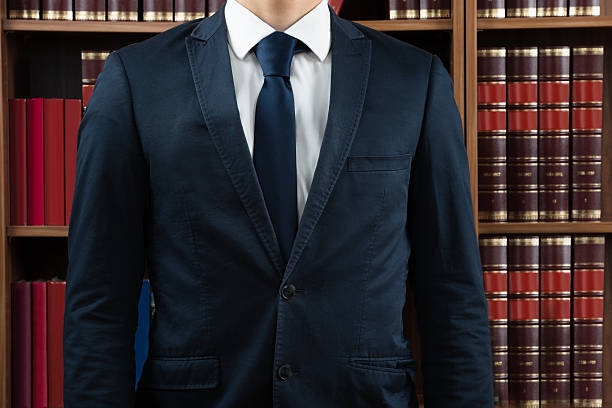 istock Midsection Of Lawyer Standing Against Bookshelf 585804152