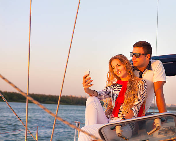 istock Beautiful couple taking selfie on a sailing boat at summer 585804320
