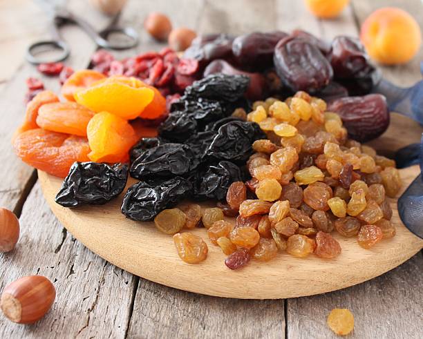 istock Dried apricots, dates, raisins, vintage wooden background, selective focus 585805334