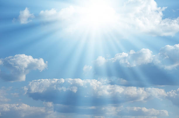 istock Bright sun shines among the white clouds 585805460