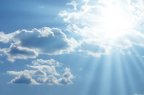 istock Bright sun shines among the white clouds 585805538