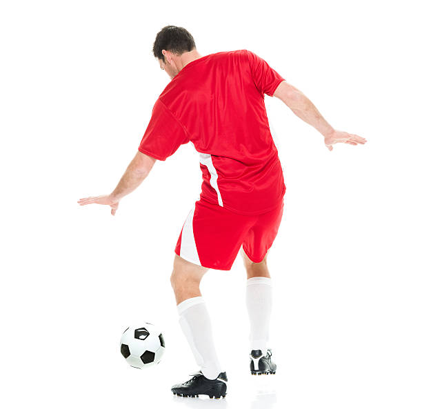 istock Rear view of soccer player dribbling 585807570