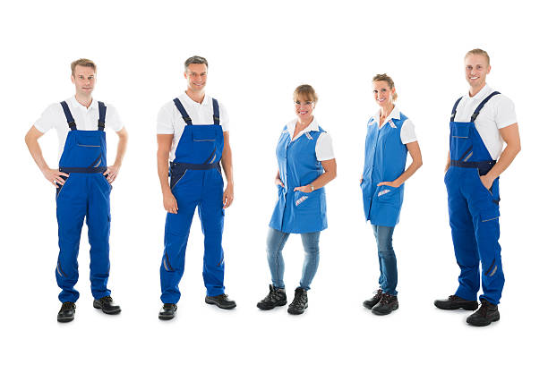 istock Portrait Of Confident Janitors Standing In Row 585807678