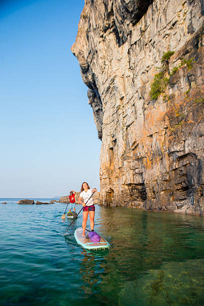 istock Attractive Young couple Stand Up Paddle Boarding 585810738