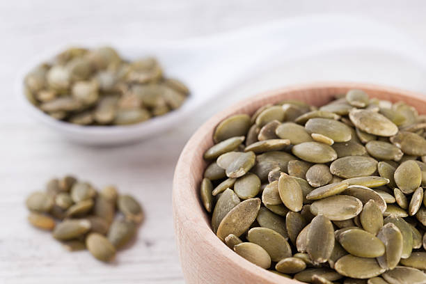 istock shelled pumpkin seeds isolated on white background 586043246