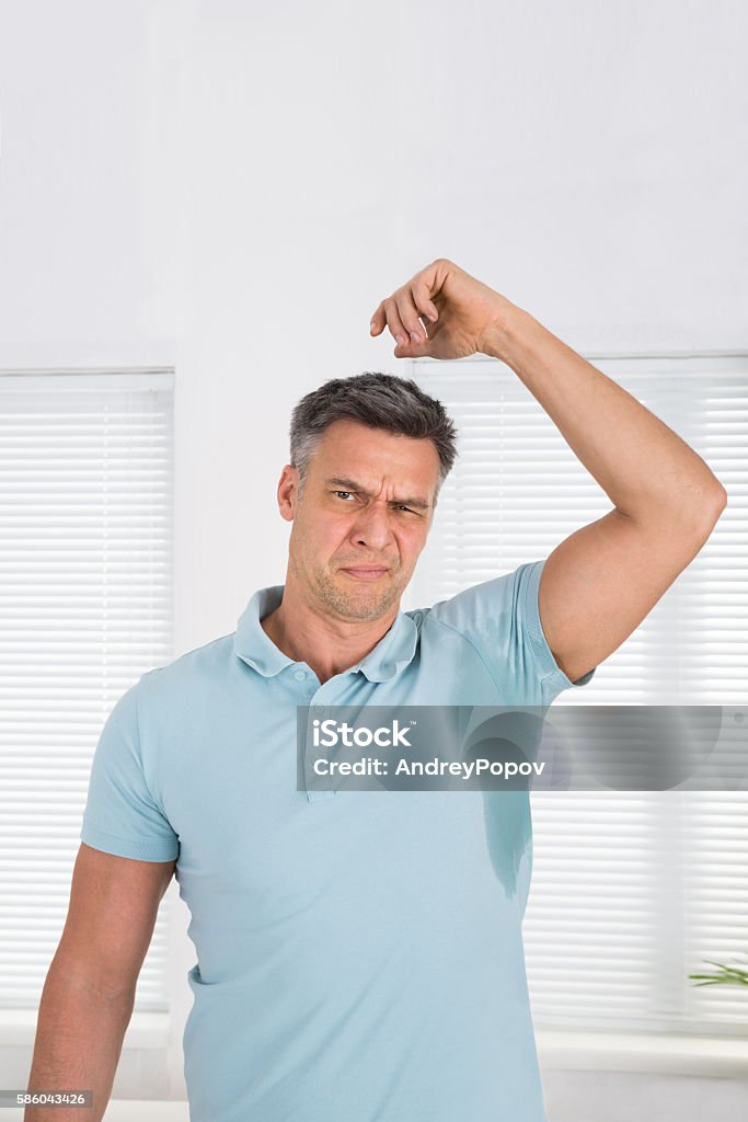 Man Sweating Very Badly Under Armpit Man With Hyperhidrosis Sweating Very Badly Under Armpit At Home Hyperhidrosis Stock Photo