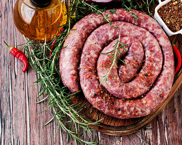istock raw beef sausages on a cast-iron pan, selective focus 586043448
