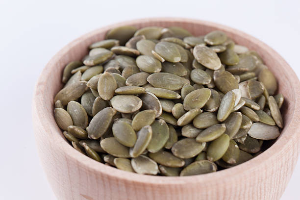 istock shelled pumpkin seeds isolated on white background 586043516
