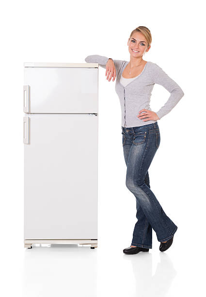 istock Woman Leaning On Refrigerator Over White Background 586043566