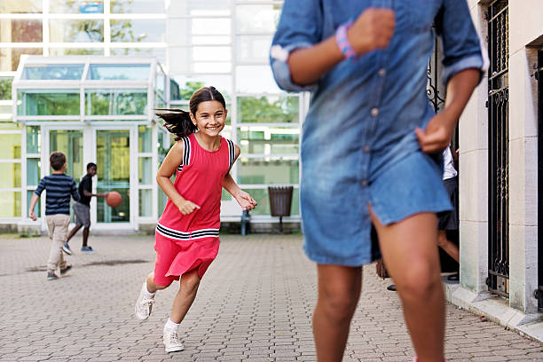 istock School kids running at school 586043972