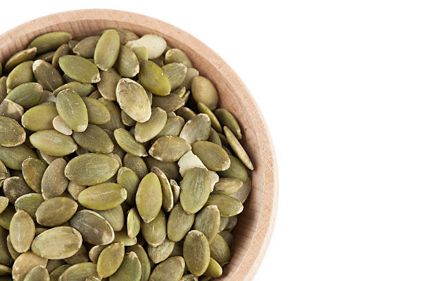 istock shelled pumpkin seeds isolated on white background 586044002