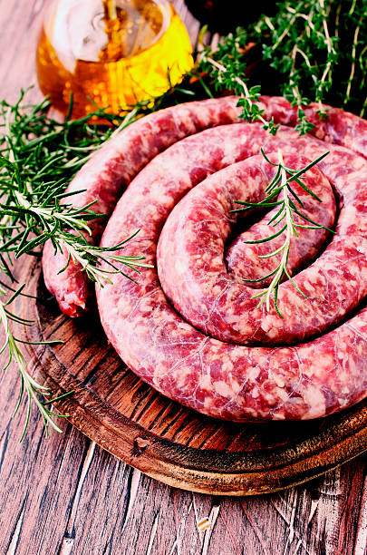 istock raw beef sausages on a cast-iron pan, selective focus 586044220
