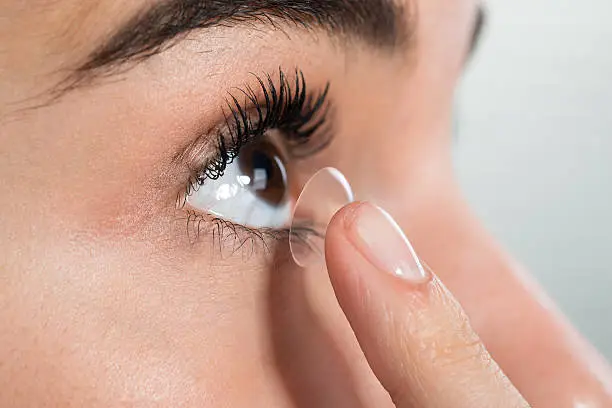 Photo of Woman Wearing Contact Lens At Home
