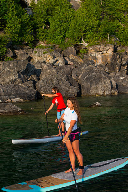 istock Attractive Young couple Stand Up Paddle Boarding 586044736