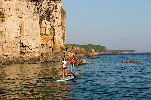 istock Attractive Young couple Stand Up Paddle Boarding 586044892