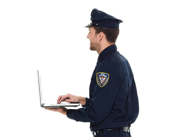 istock Smiling police working on laptop 586044950