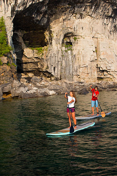istock Attractive Young couple Stand Up Paddle Boarding 586045012