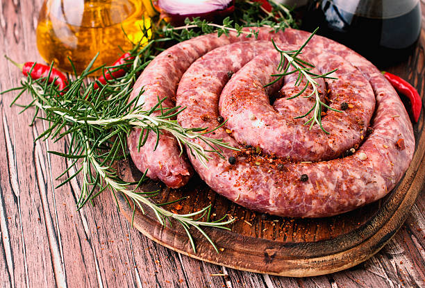 istock raw beef sausages on a cast-iron pan, selective focus 586045150