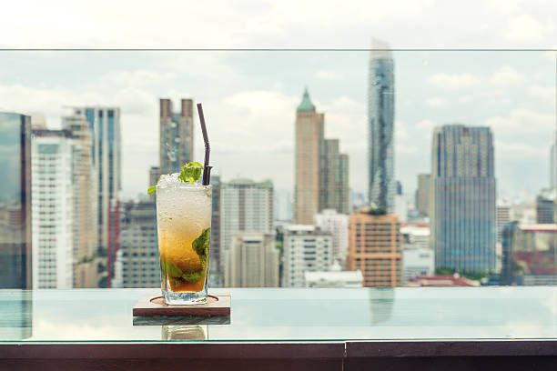 istock Mojito cocktail on table in rooftop bar with Bangkok city. 586045184