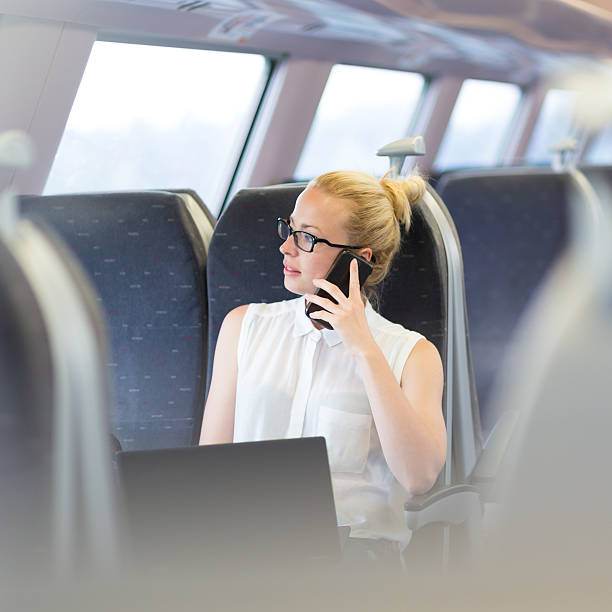 istock Business woman working while travelling by train. 586046346