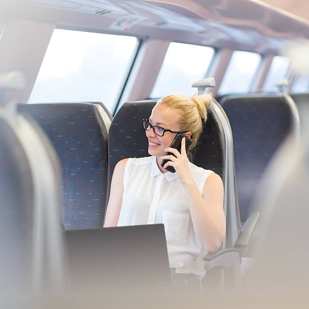 istock Business woman working while travelling by train. 586046358